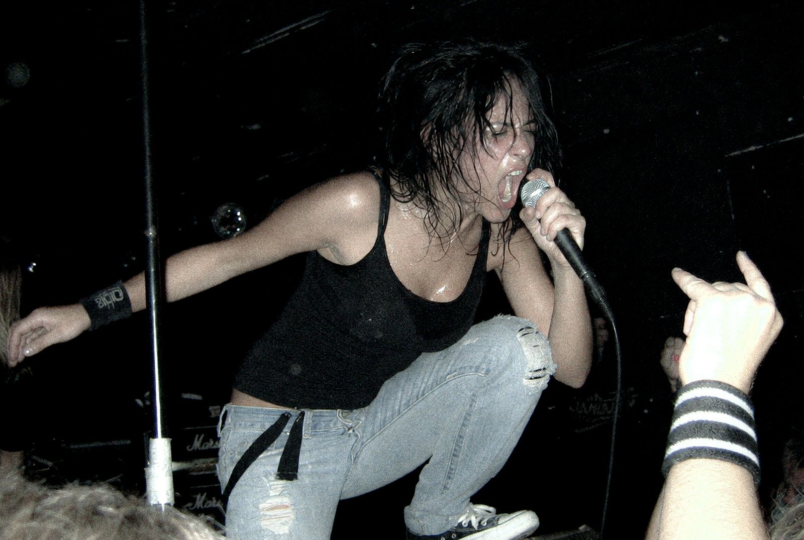 ForF's singer screaming into the microphone mid-set, crouched low over the front row.